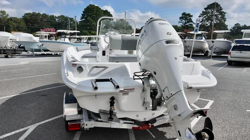 Slide: The Image of 2026 ALK2 Powerboats 18 CRS with Suzuki outboard motor in a boat dealership lot. - 2