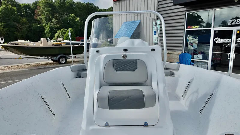 Slide: The Image of 2026 ALK2 Powerboats 18 CRS with gray seating, parked outside a dealership. - 9