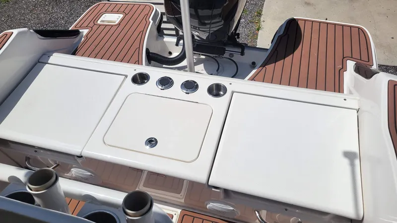 Slide: The Image of 2024 Trophy T20CC boat deck with wood finish and storage compartments. - 16
