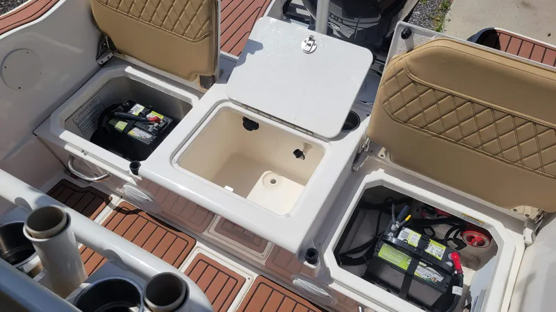 Slide: The Image of 2024 Trophy t20cc boat interior with open storage compartments and visible batteries. - 17