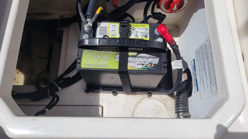 Slide: The Image of Marine battery setup in a 2024 Trophy t20cc boat compartment. - 18