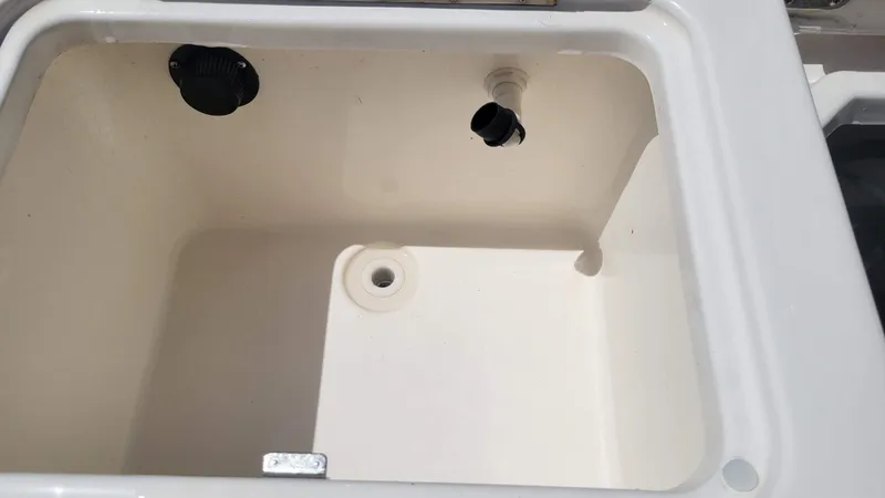 Slide: The Image of 2024 Trophy T20CC boat compartment with drainage and fittings, white interior. - 19