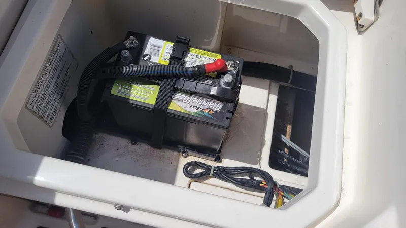 Slide: The Image of Battery compartment of a 2024 Trophy t20cc boat, featuring a marine battery. - 20