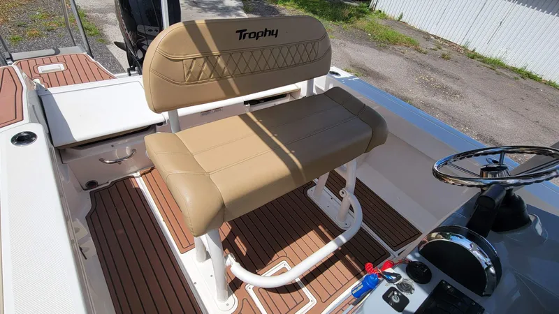 Slide: The Image of 2024 Trophy T20CC boat interior with tan seating and wood-style flooring. - 23