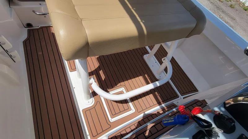 Slide: The Image of 2024 Trophy T20CC boat interior with tan seat and wood-patterned flooring. - 24
