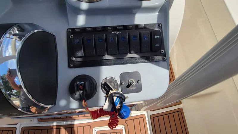 Slide: The Image of Control panel of 2024 Trophy t20cc boat with switches and ignition. - 28