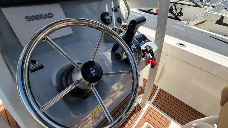 Slide: The Image of Steering wheel and controls of 2024 Trophy t20cc boat with Simrad electronics. - 29