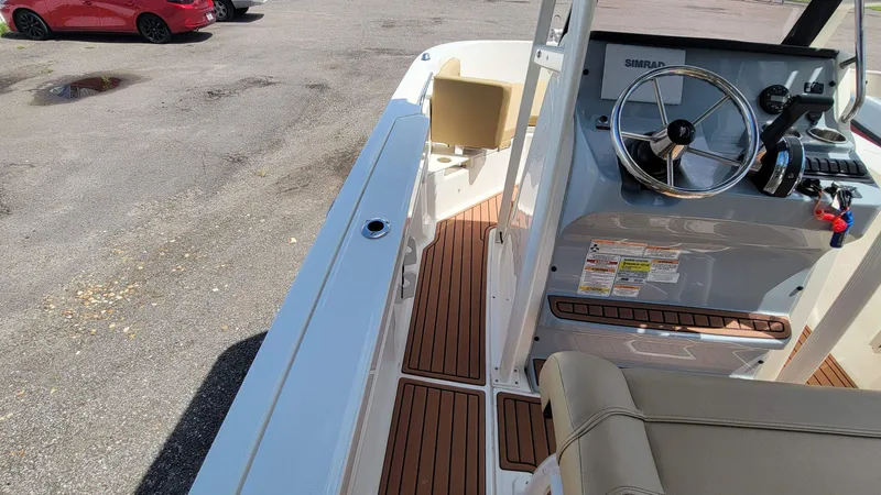 Slide: The Image of 2024 Trophy T20CC boat interior with steering wheel and wood-patterned flooring. - 31