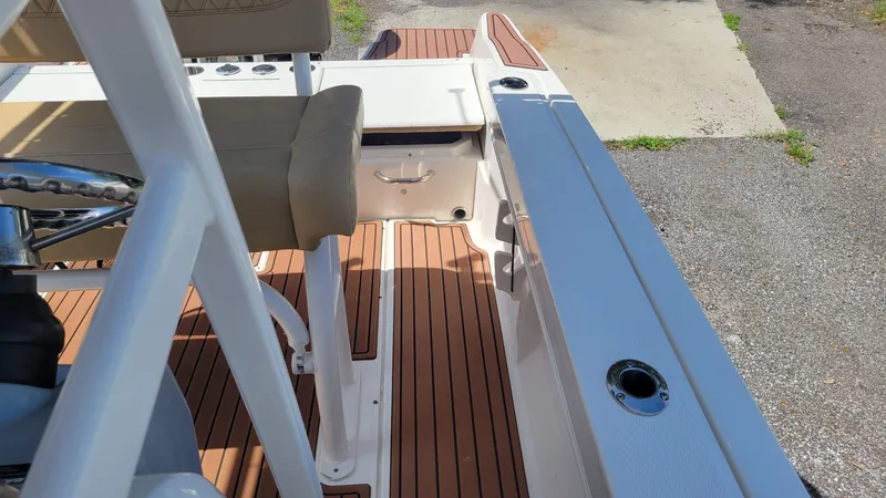 Slide: The Image of 2024 Trophy t20cc boat interior with tan seating and wood-style flooring. - 36