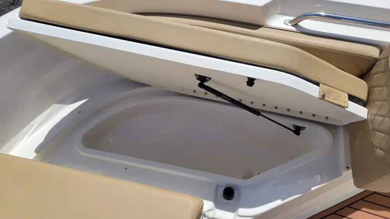Slide: The Image of Open storage compartment in a 2024 Trophy T20CC boat with beige seating. - 39
