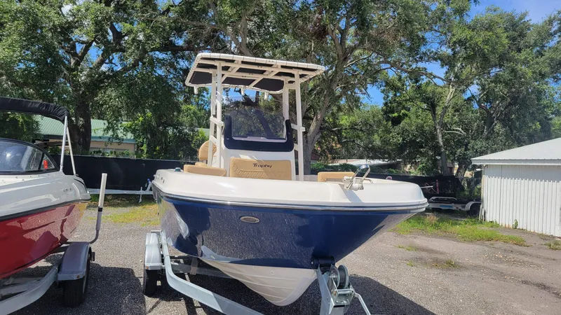 Slide: The Image of 2024 Trophy t20cc boat on trailer, parked outdoors with trees in background. - 4