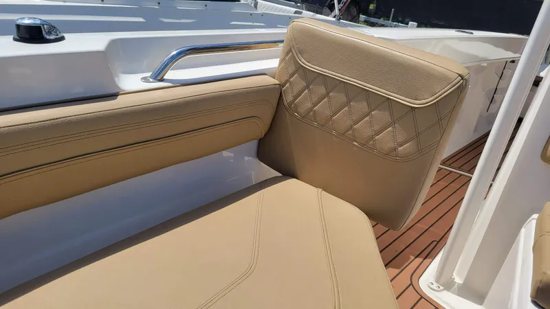Slide: The Image of 2024 Trophy T20CC boat interior with tan leather seating and wood-style flooring. - 49