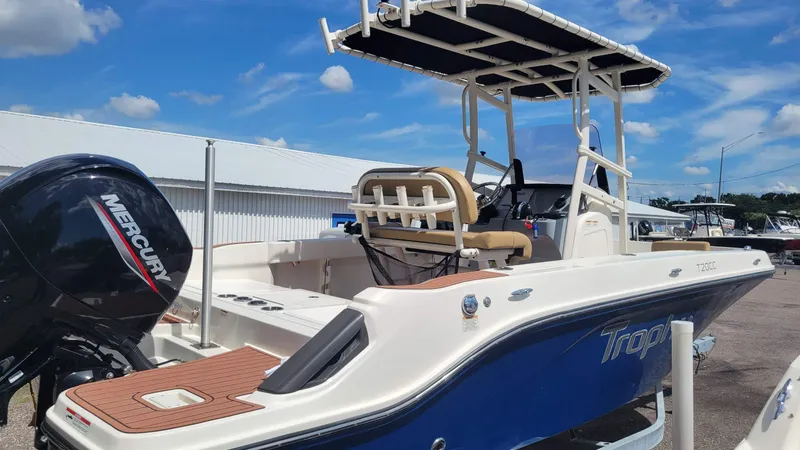 Slide: The Image of 2024 Trophy T20CC boat with Mercury engine, docked under a clear blue sky. - 6