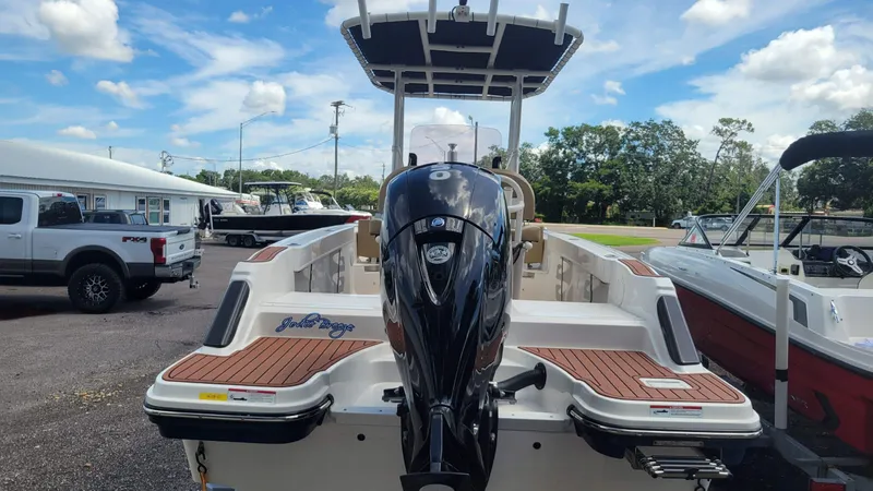 Slide: The Image of 2024 Trophy T20CC boat with powerful outboard motor, parked outdoors under a clear sky. - 9
