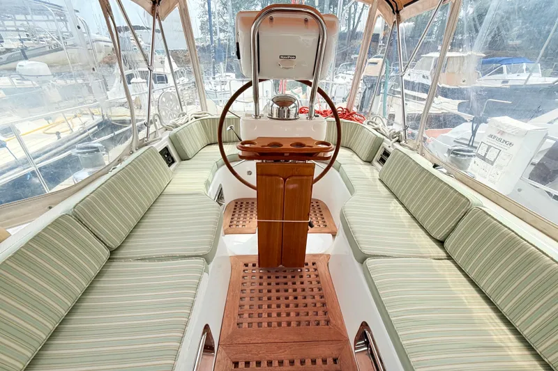Slide: The Image of Spacious cockpit of 2008 Hylas 46 yacht with striped seating and wooden flooring. - 19