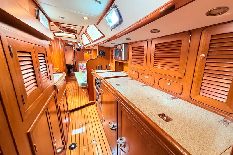 Slide: The Image of Luxurious 2008 Hylas 46 yacht interior with wooden cabinetry and modern amenities. - 27