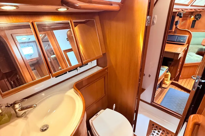 Slide: The Image of Luxurious 2008 Hylas 46 yacht bathroom with wooden cabinetry and modern fixtures. - 32