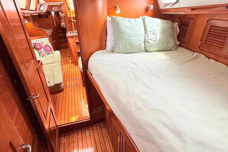 Slide: The Image of Cozy cabin interior of 2008 Hylas 46 yacht with wooden finish and comfortable bedding. - 34
