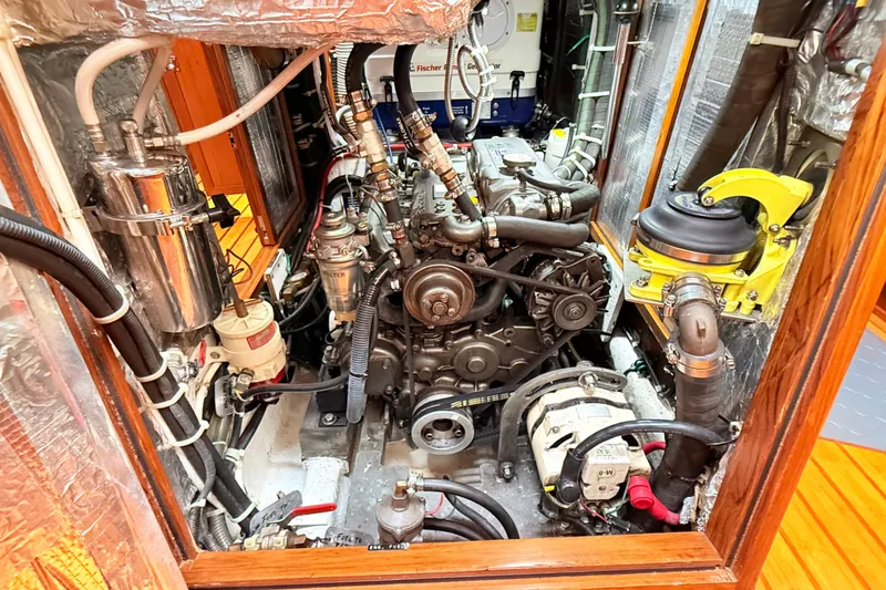 Slide: The Image of Engine compartment of a 2008 Hylas 46 yacht, showcasing detailed mechanical components. - 38