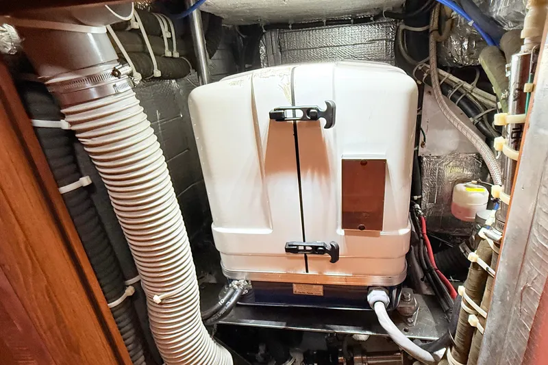 Slide: The Image of Engine room of a 2008 Hylas 46 yacht with visible machinery and piping. - 40