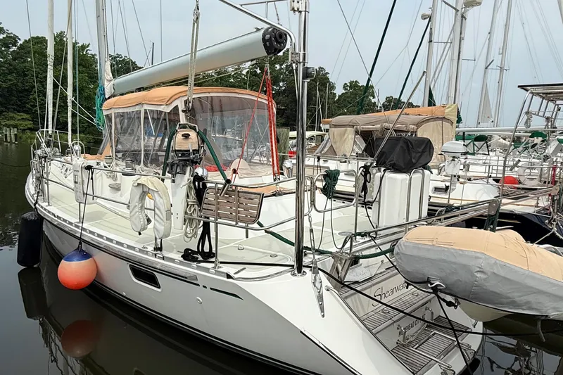 Slide: The Image of Sailboat Hylas 46, 2008 model, docked in a marina with surrounding vessels. - 5