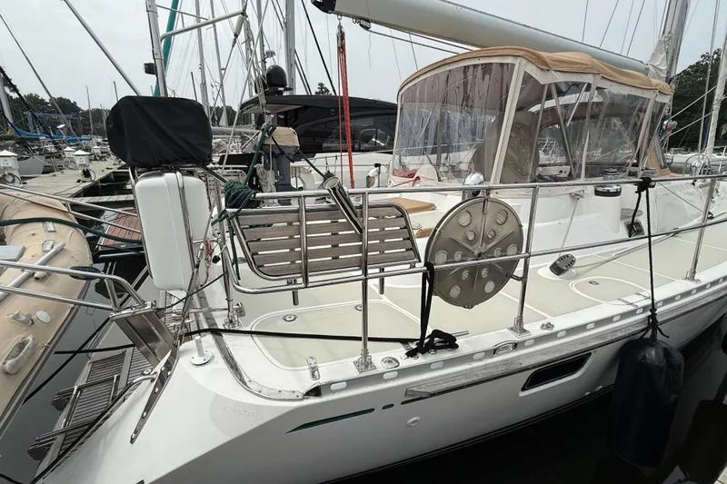 Slide: The Image of 2008 Hylas 46 sailboat docked at marina, featuring sleek design and spacious deck. - 7