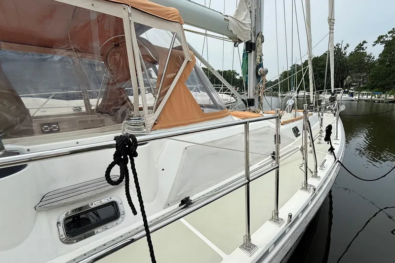 Slide: The Image of 2008 Hylas 46 sailboat docked, featuring sleek design and orange canopy. - 8