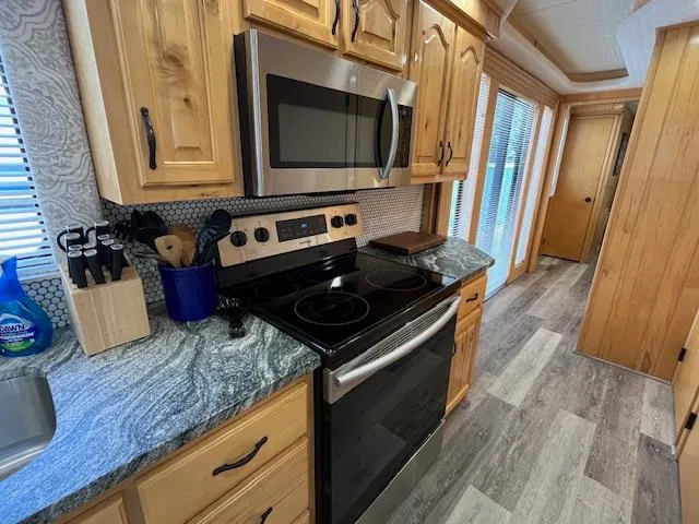 Slide: The Image of Modern kitchen in a 2001 Horizon 16 x 70 houseboat with stainless steel appliances. - 10