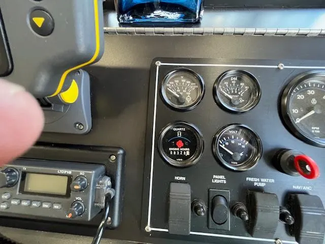 Slide: The Image of Control panel of a 2001 Horizon 16 x 70 Houseboat with gauges and switches. - 13