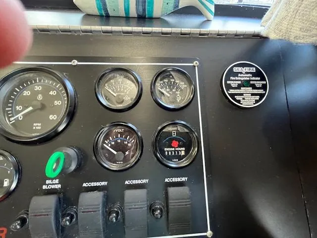 Slide: The Image of Control panel of a 2001 Horizon 16 x 70 Houseboat with gauges and switches. - 14