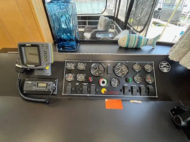 Slide: The Image of Control panel of a 2001 Horizon 16 x 70 Houseboat with gauges and navigation equipment. - 15