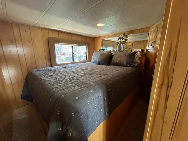 Slide: The Image of Cozy bedroom in 2001 Horizon 16 x 70 houseboat with wood paneling and window view. - 18