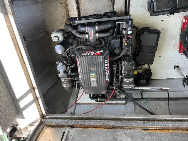 Slide: The Image of Engine compartment of a 2001 Horizon 16 x 70 Houseboat, featuring a Mercury 5.0L engine. - 30