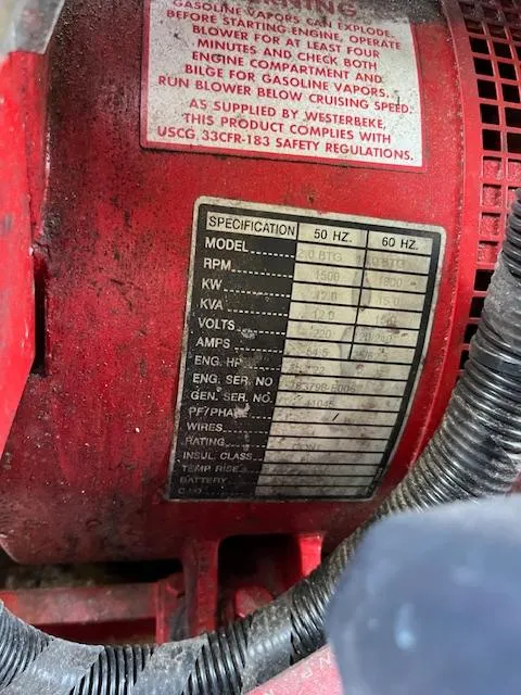 Slide: The Image of Close-up of a red engine label with specifications for a 2001 Horizon 16 x 70 Houseboat. - 32
