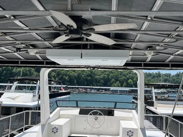 Slide: The Image of 2001 Horizon 16 x 70 Houseboat interior with ceiling fan and scenic marina view. - 35