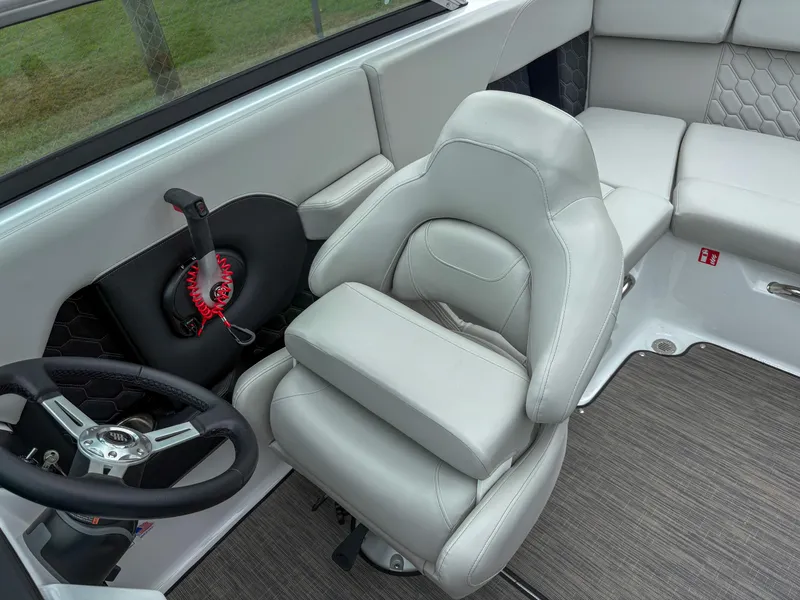 Slide: The Image of 2026 Four Winns H2 Freedom boat interior with plush seating and modern steering wheel. - 11