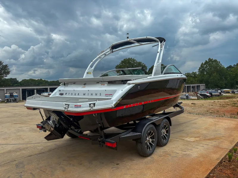 Slide: The Image of 2026 Four Winns H2 Freedom boat on trailer under cloudy sky. - 3