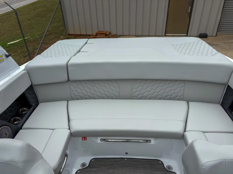 Slide: The Image of 2026 Four Winns H2 Freedom boat interior with gray cushioned seating and hexagonal pattern. - 5