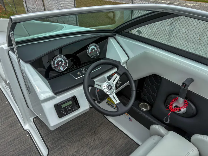 Slide: The Image of 2026 Four Winns H2 Freedom boat dashboard with steering wheel and control panel. - 7