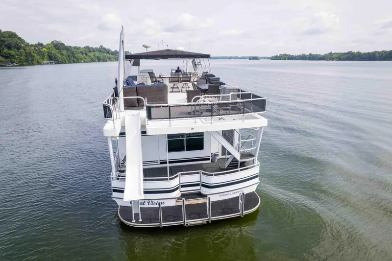 Slide: The Image of 2008 Monticello houseboat on a serene lake with upper deck seating and slide. - 12
