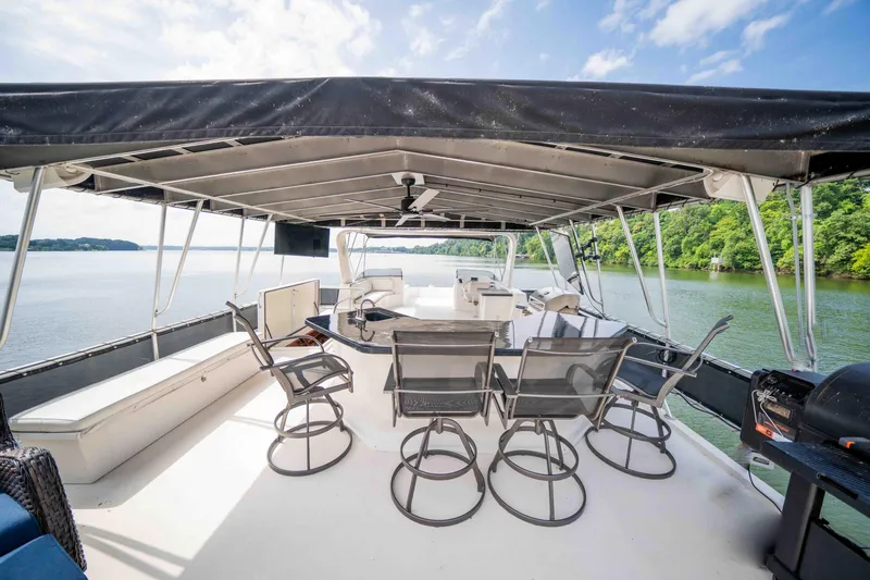 Slide: The Image of Spacious deck of 2008 Monticello houseboat with seating, canopy, and scenic lake view. - 18