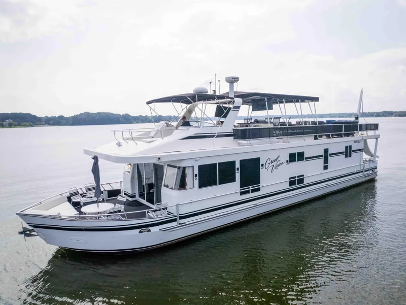 Slide: The Image of 2008 Monticello houseboat on calm water, featuring spacious decks and modern design. - 2