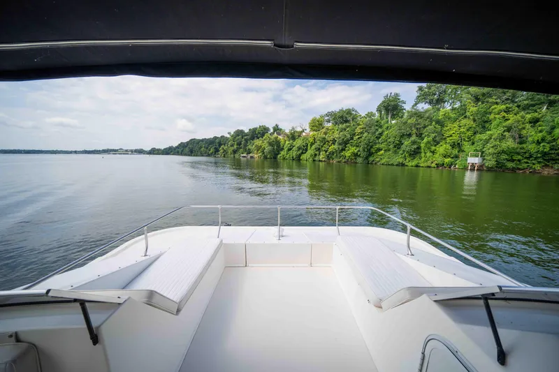 Slide: The Image of 2008 Monticello houseboat deck with scenic river and lush green shoreline view. - 23