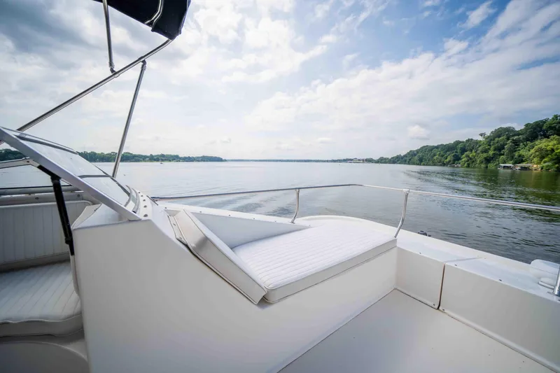 Slide: The Image of 2008 Monticello houseboat deck with scenic lake view and lush shoreline. - 24