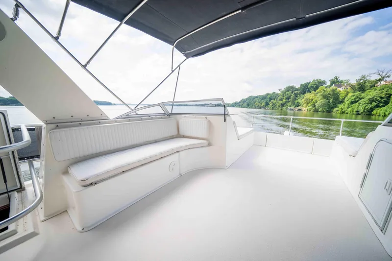 Slide: The Image of Spacious deck of 2008 Monticello houseboat with seating, overlooking serene lake and lush greenery. - 25