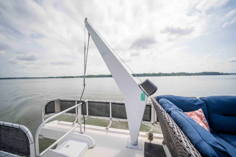 Slide: The Image of 2008 Monticello houseboat deck with seating, overlooking calm lake and cloudy sky. - 28