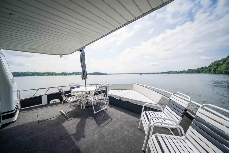 Slide: The Image of Sunny deck of 2008 Monticello houseboat with chairs and table overlooking serene lake. - 30