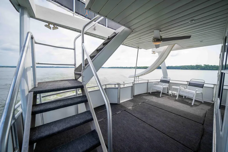 Slide: The Image of 2008 Monticello houseboat deck with stairs, seating, and lake view. - 34
