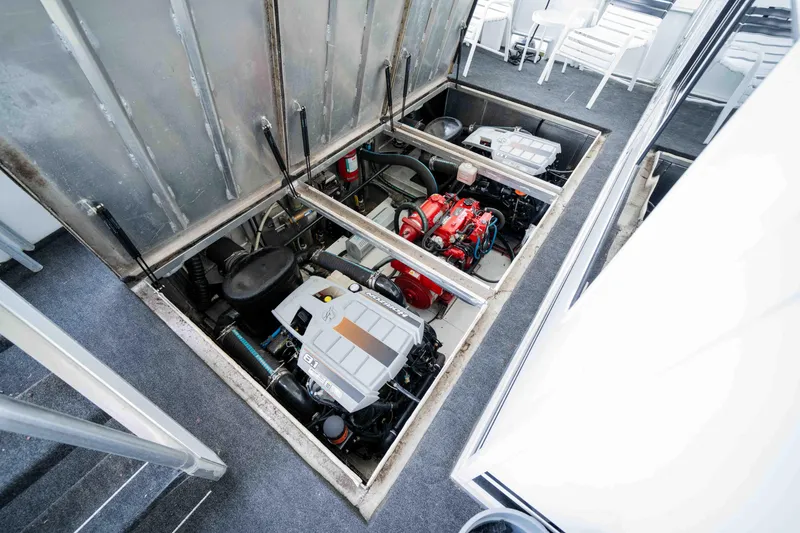 Slide: The Image of Engine compartment of a 2008 Monticello houseboat, showcasing dual engines and mechanical components. - 38