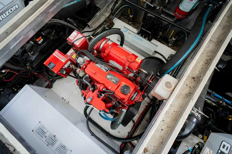 Slide: The Image of Engine compartment of a 2008 Monticello Houseboat, featuring a red engine and various components. - 40